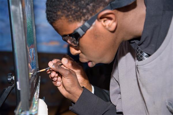 Keimonte Carr focused on painting. 